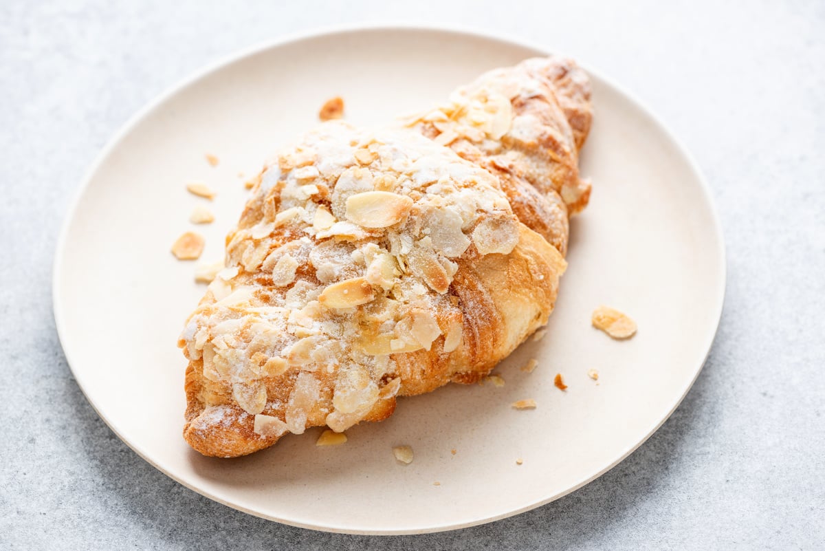 Almond croissant on a plate closeup view