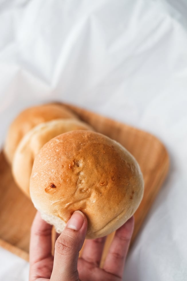 Hand Holding a Pandesal Bread